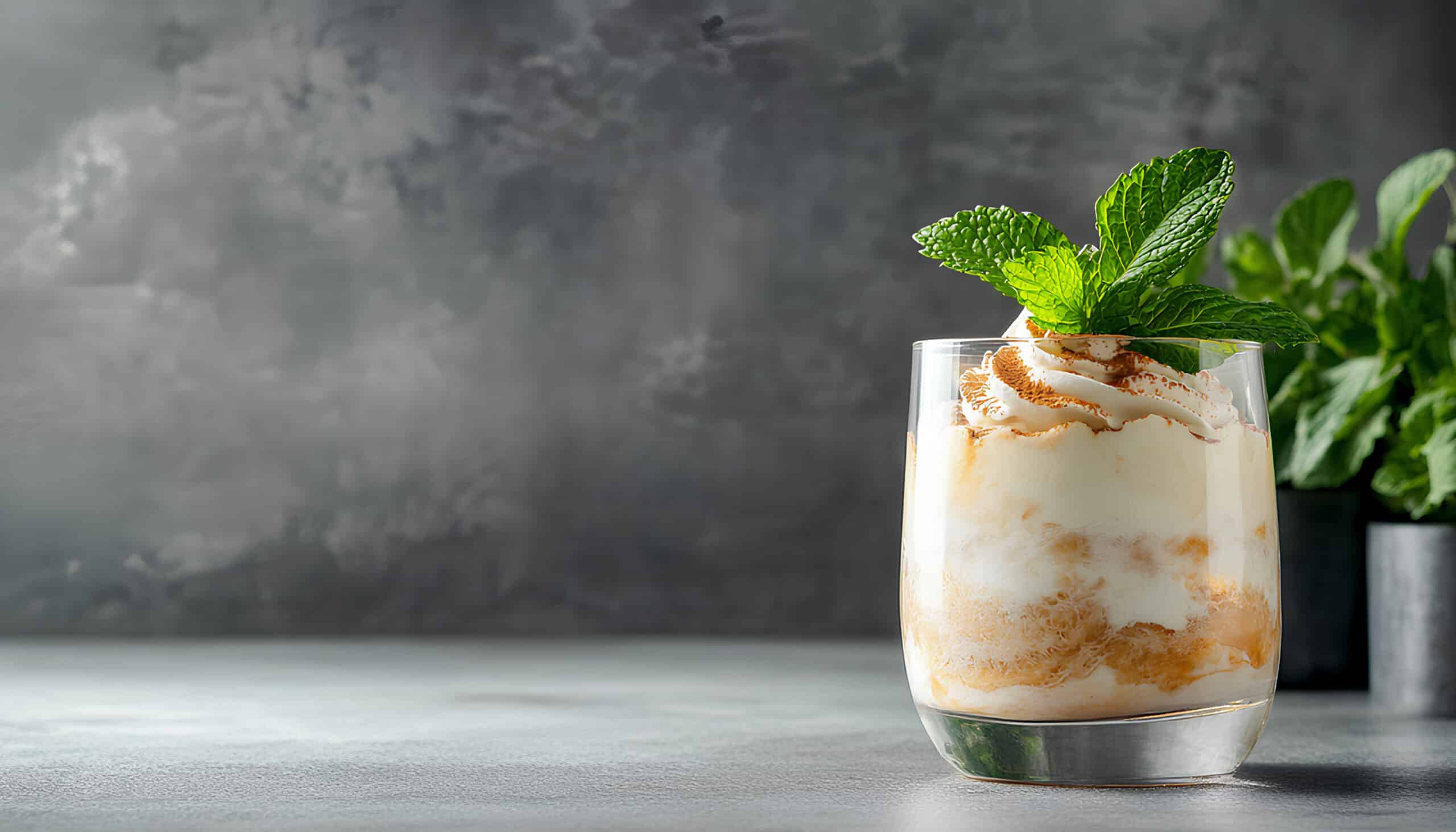 A sweet mousse in a glass topped with mint