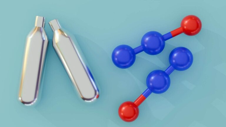 Models of nitrous oxide (N2O) molecules next to cream chargers